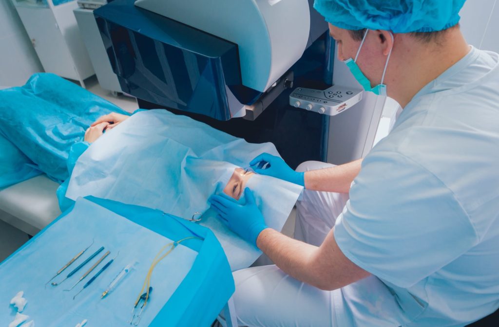 A male surgeon prepping a woman for laser eye surgery