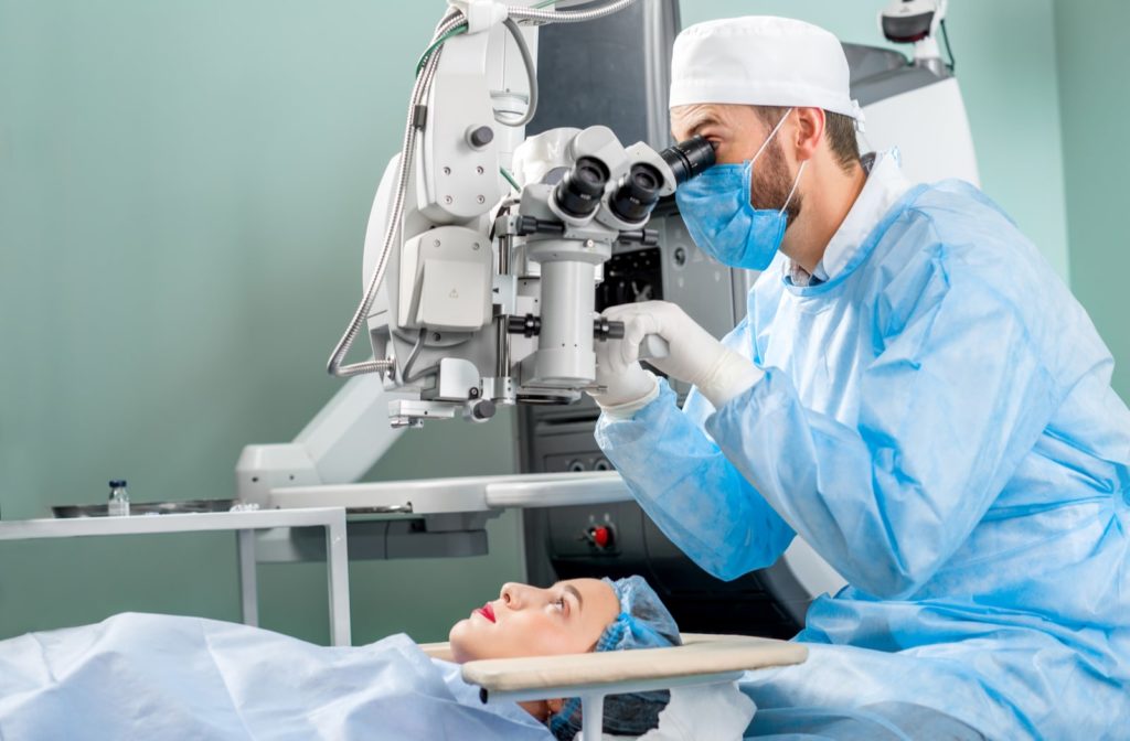 A surgeon preparing for cataract surgery on a woman